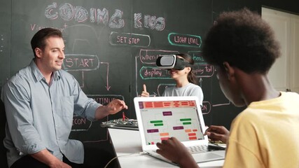 Caucasian school girl wear VR glass and showing thumb up while african boy working on laptop at blackboard coding engineering prompt written in STEM class. Creative education concept. Edification - Powered by Adobe