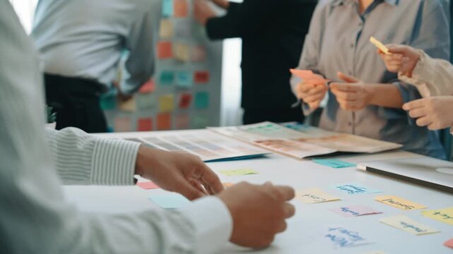 A bright office scene capturing a collaborative brainstorming session where diverse team members actively share ideas and feedback through colorful notes and creative discussion. SACTR
