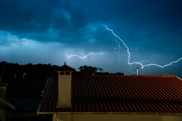 Lightning storm over quiet residential street at night
