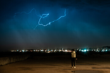 Lightning storm over quiet residential street at night