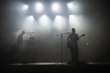Silhouette of rock star with guitar on the stage