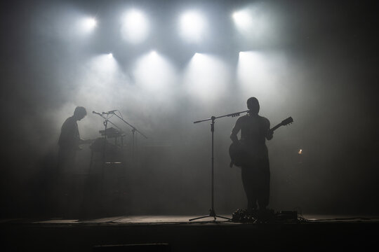 Silhouette of rock star with guitar on the stage
