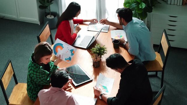 Top view of project manager present financial graph to investors at meeting. Professional marketing team brainstorming financial idea while looking at financial statistic from laptop. Convocation.