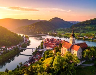 Aerial view of a picturesque town beside a river and surrounded by mountains