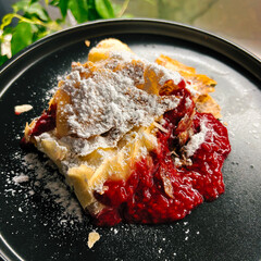 Golden puff pastry with raspberry filling and sugar topping