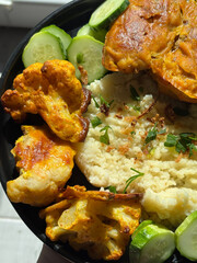 Couscous bowl with fried cauliflower and fresh cucumber