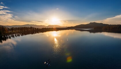 Obraz premium drone flying over lake at sunrise reflection