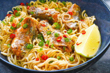 Spicy sardine noodles in tomato sauce with chillies in a bowl. Asian food style.