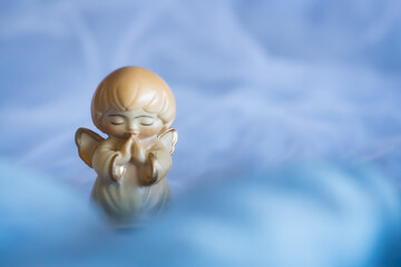 Guardian angel - wooden angel on a blue background	