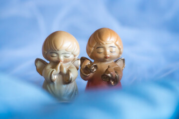 Guardian angel - wooden angels on a blue background	