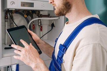 Repairman performing maintenance on a gas boiler in a residential bathroom