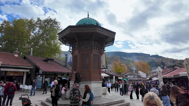 Sarajevo, Bosnia and Herzegovina &ndash; October 25, 2025: Central view of Sebilj Fountain surrounded by people in Bascarsija, Sarajevo&rsquo;s old bazaar district