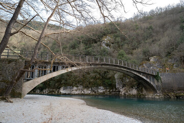 Aerial view of voidomatis river with the clear waters and the famous bridge in epirus Greece