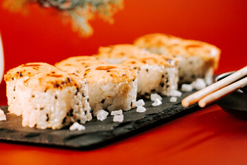 Delicious sushi rolls arranged on a slate platter with contrasting colors and textures