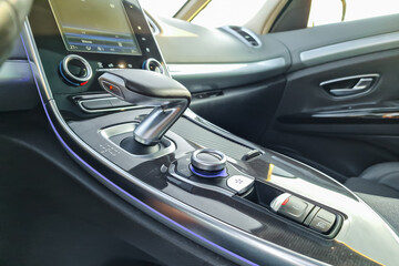 Luxury car interior showcases modern technology and elegant design in a sleek cabin setting with sunlight pouring through