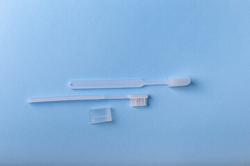 White toothbrushes from above on blue background. Oral care, gum and teeth health. Morning routine and health care.