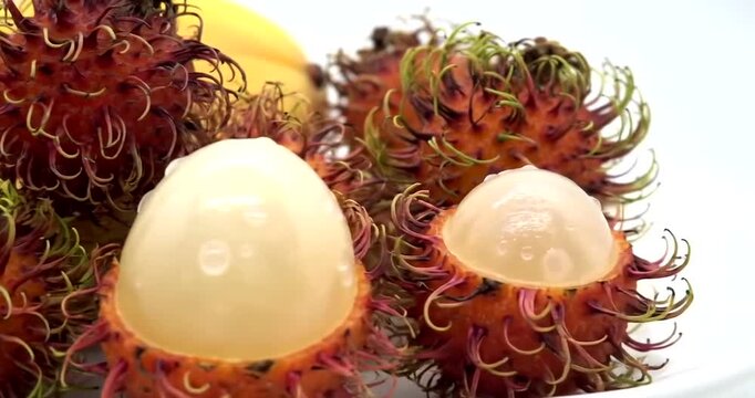 Fresh rambutan fruit on a plate, showcasing its unique texture and color