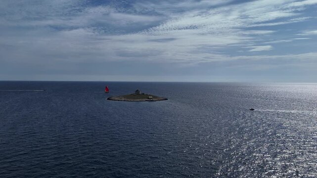 Pokonji Dol Lighthouse with red sailboat, Hvar, Croatia