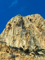Magnificent rocky cliff under a vivid blue sky on a bright sunny day in a serene outdoor landscape