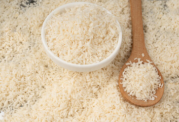 Grated coconut powder. Dry coco flakes pile, shredded desiccated coconut, tropical fruit chips