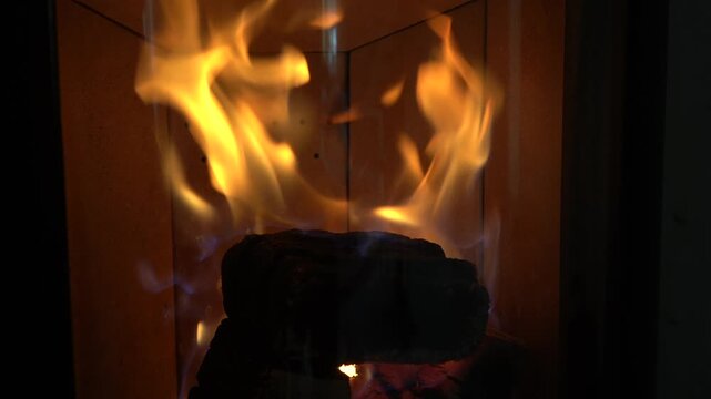 A fireplace with fire. A fire is burning in the fireplace. An atmosphere of coziness and warmth.