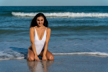 Sunlit Serenity: A Stunning Bikini Model Radiates Beauty by the Ocean