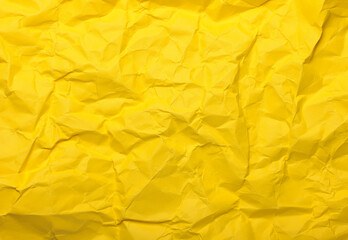 Yellow crumpled paper creating an abstract texture background