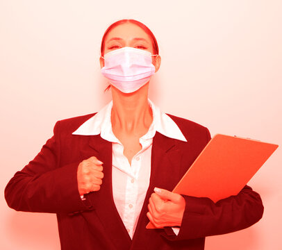 Portrait of young man with face mask back at work in office after lockdown. Woman mask face. Flu. Medical. Pandemic