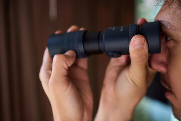A Person Diligently Using a Telescope for Detailed Observation of the Night Sky and Beyond