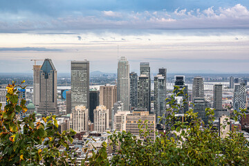 Panoramic view of downtown Montreal skyline with modern skyscrapers, office towers and urban architecture under blue cloudy sky, Quebec, Canada.