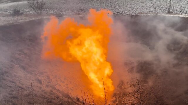 Ukraine, Shebelinka gas field engineers release and ignite problematic gas and gas condensate in a special barn for safety during a snowfall in winter
