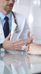 Doctor consulting patient in clinic, discussing medical issues, providing healthcare advice and professional communication. Medicine and health care
