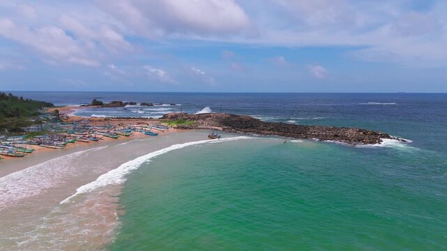 Aerial View of Fishing Boat Pulled Into Turquoise Ocean Waves at Tropical Beach