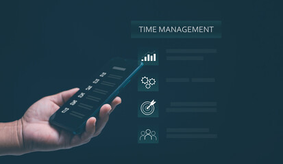 Concept of time management and productivity planning. Hand holding smartphone with digital calendar on screen with business icons. Organization scheduling, efficiency and smart technology for success.
