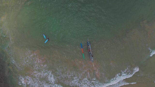 Top-Down Drone Tracking of Fishing Boat and Surfers on Turquoise Tropical Coast