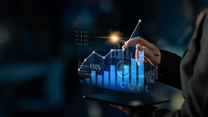 A professional interacts with a digital display of statistics and graphs, showcasing analytics and...