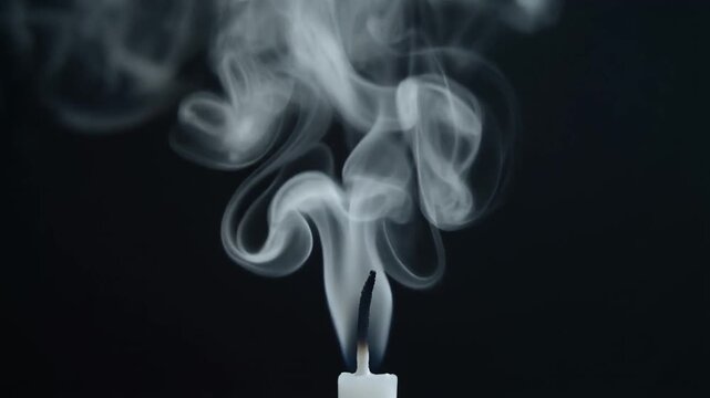 Snuffed Candle Smoke Loop. A single, recently extinguished candle wick. Mesmerizing wisp of white smoke rises from the black wick in a beautiful.
