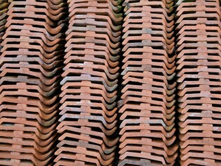 Close-up background of a row of clay roof tiles from a top angle. The arrangement of roof tiles for the background.