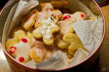 Tin shaped like a person filled with decorated cookies