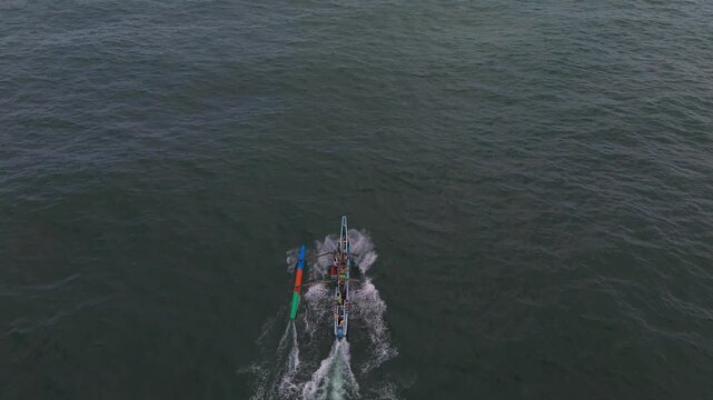 Aerial Tracking Shot of Traditional South Asian Outrigger Fishing Boat at Sea