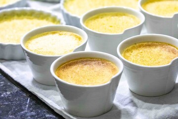 Crème brûlée, creme brulée. Classic creme brulée being flambéed. Burning, flames, cabbage, vanilla bean, blowtorch, sugar, blowtorch.