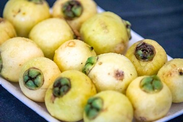 Yellow rose apple or white rose apple, Syzygium jambos. Native to Southeast Asia, this species belongs to the Myrtaceae family, a wild fruit with a rose petal flavor and aroma.