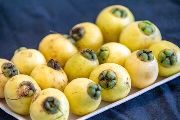 Yellow rose apple or white rose apple, Syzygium jambos. Native to Southeast Asia, this species belongs to the Myrtaceae family, a wild fruit with a rose petal flavor and aroma.