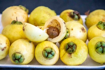 Yellow rose apple or white rose apple, Syzygium jambos. Native to Southeast Asia, this species belongs to the Myrtaceae family, a wild fruit with a rose petal flavor and aroma.