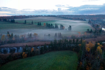 Aerial view of colorful autumn forest with morning mist of Prince Edward Island Canada. High...