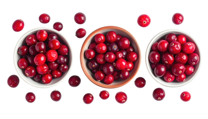 Three bowls filled with shiny, red cranberries scattered on a dark background, creating a vibrant and appetizing display