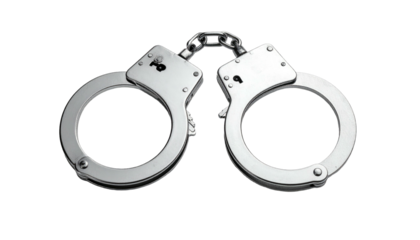 Silver metal handcuffs, isolated against a black background, linked with a chain