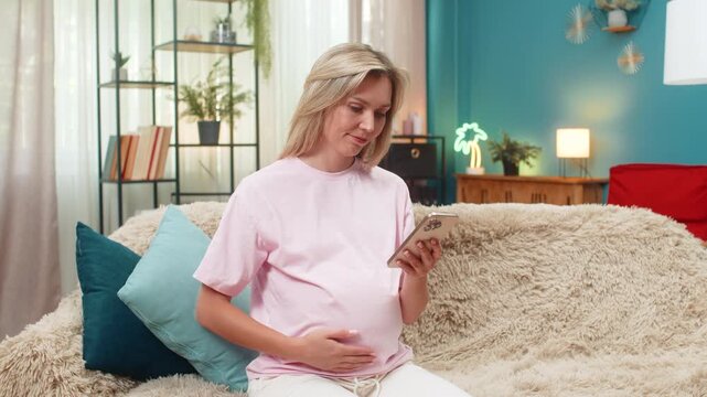 Pregnant middle-aged woman at home sighs using smartphone after losing online game shoulders in defeat. Caucasian girl on sofa shows sad face shaking head staring at mobile phone screen feeling upset.