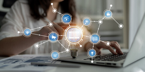 A professional woman engages with her laptop in an office setting. Digital icons symbolize connectivity and innovation, illustrating modern technology and data analysis. Crux