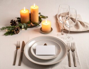 Elegant Christmas table setting with lit candles, festive decorations, and a blank place card for a mockup